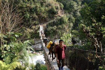 Guide und Lastpferde auf einer Brücke